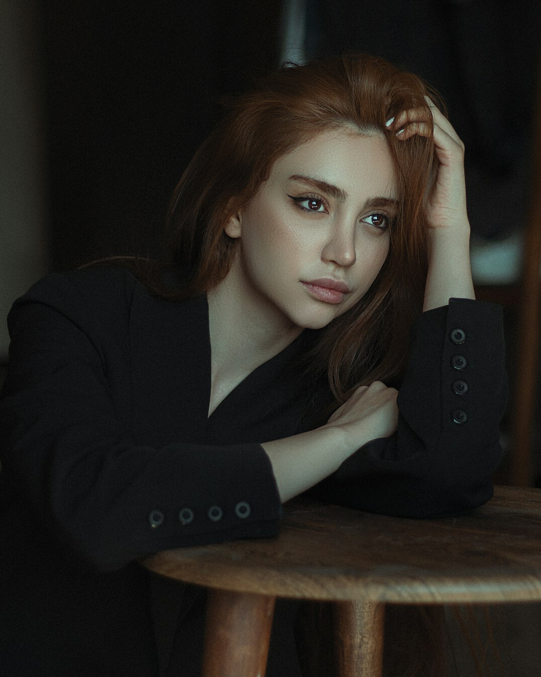 Portrait of a woman in a dark blazer smiling gently