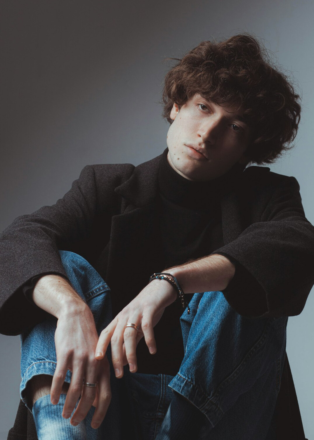 Portrait of a thoughtful man in a dark jacket in a studio