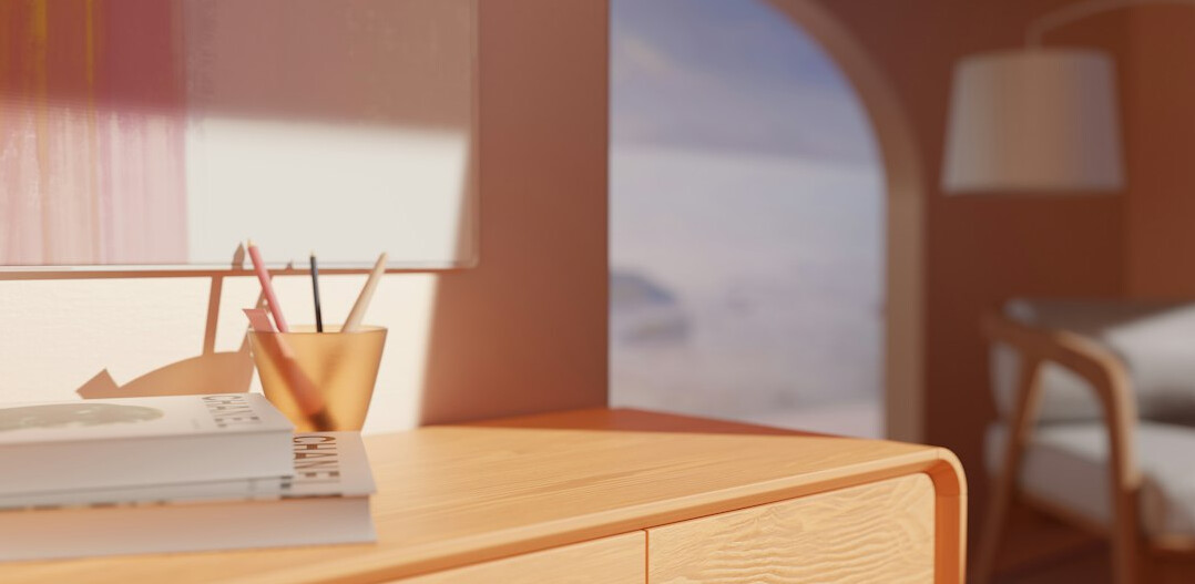 Desk with a notebook, pen and laptop in soft light